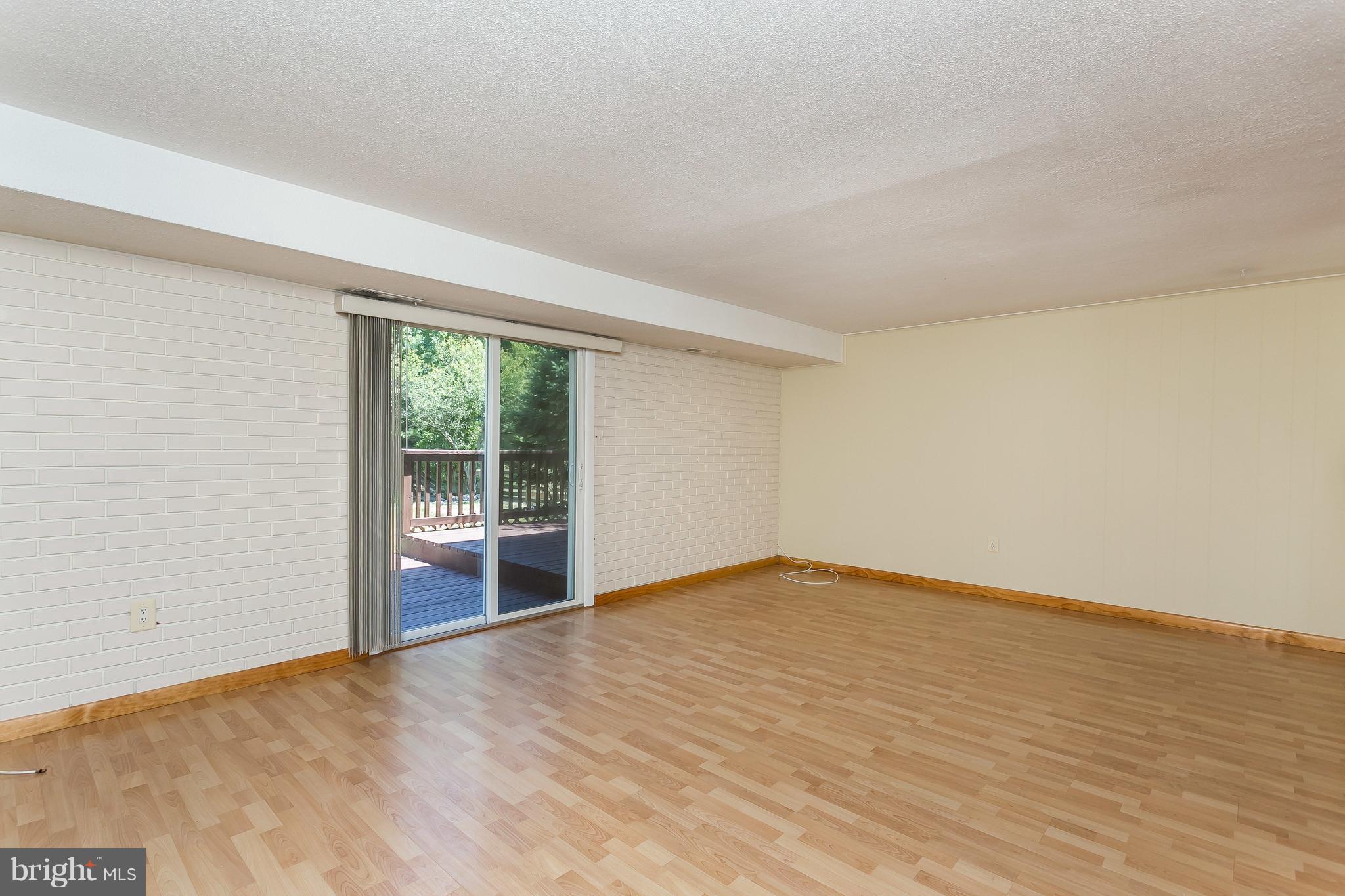 4812 Galley Road Baltimore, MD 21236 - Photo 16 of 30 a view of an empty room with wooden floor and a window