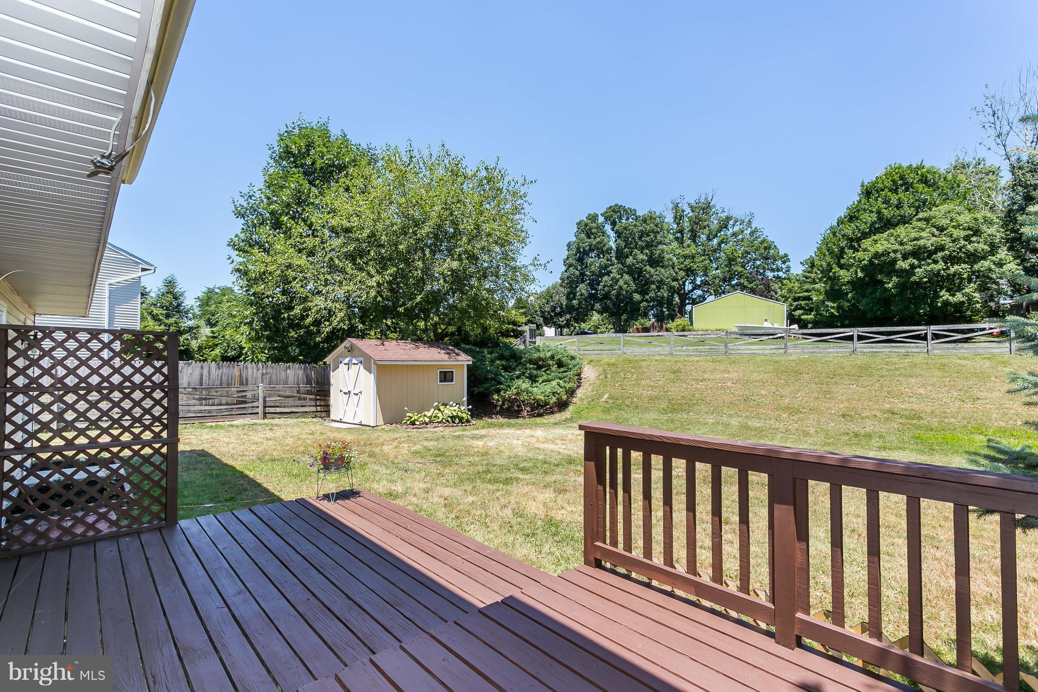 4812 Galley Road Baltimore, MD 21236 - Photo 28 of 30 a view of a wooden deck and lake with trees in the background