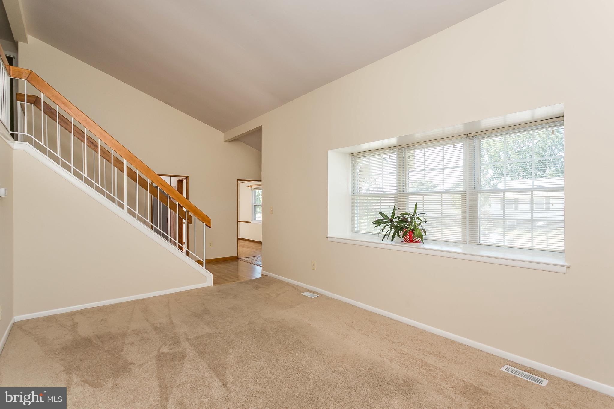 4812 Galley Road Baltimore, MD 21236 - Photo 5 of 30 a view of an empty room with wooden floor and a window