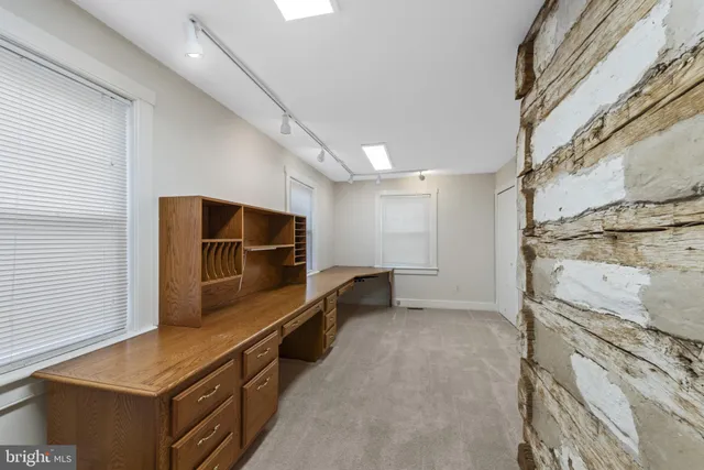 a view of an empty room and wooden floor