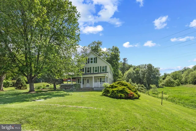 a yellow building with trees in the background