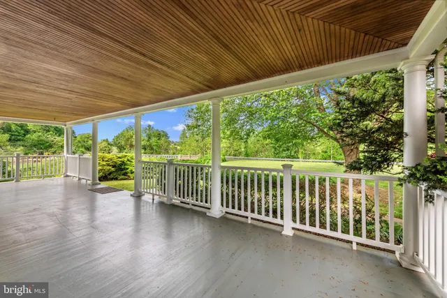 a view of a porch with wooden floor