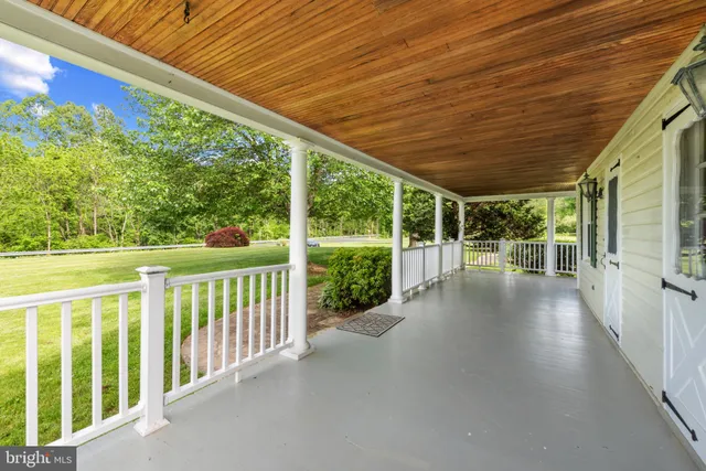 a view of a porch with wooden floor