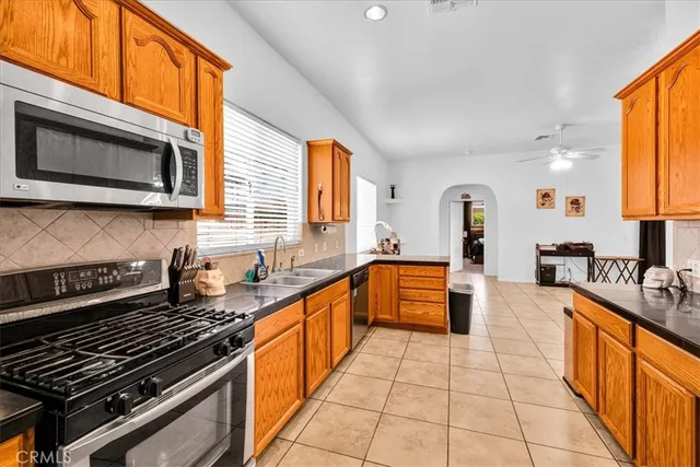 a large kitchen with a sink window and cabinets