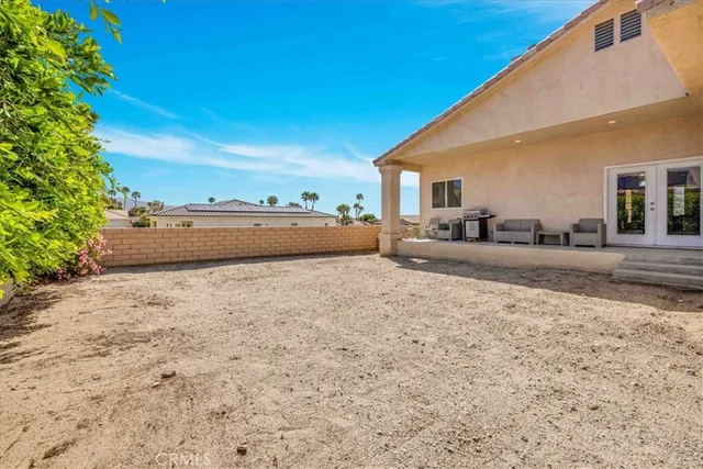 a view of a white house with a yard