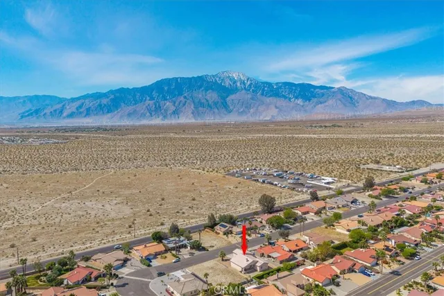 an aerial view of a houses with a swimming pool