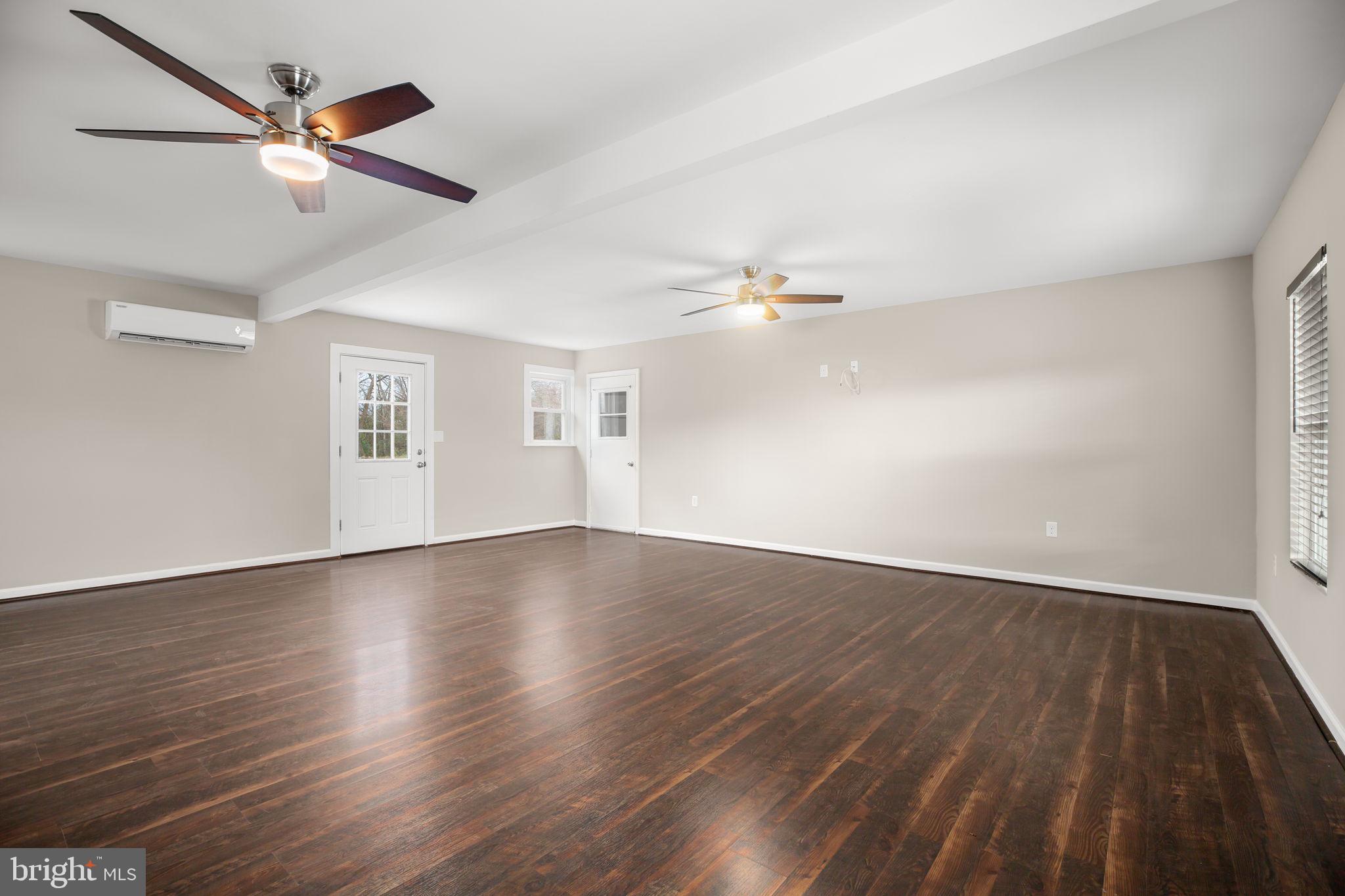 92 McCarty Road Fredericksburg, VA 22405 - Photo 12 of 31 a view of an empty room with wooden floor and a window