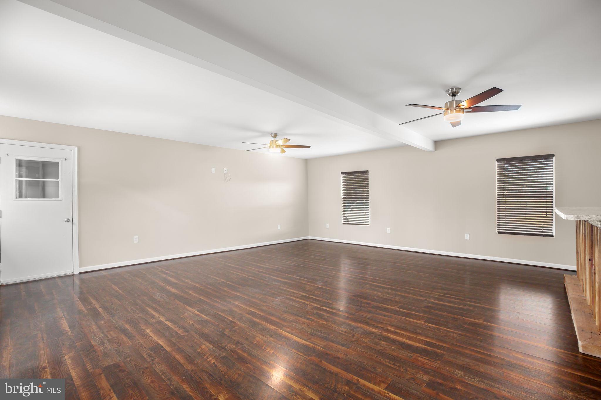 92 McCarty Road Fredericksburg, VA 22405 - Photo 15 of 39 an empty room with wooden floor and ceiling fan