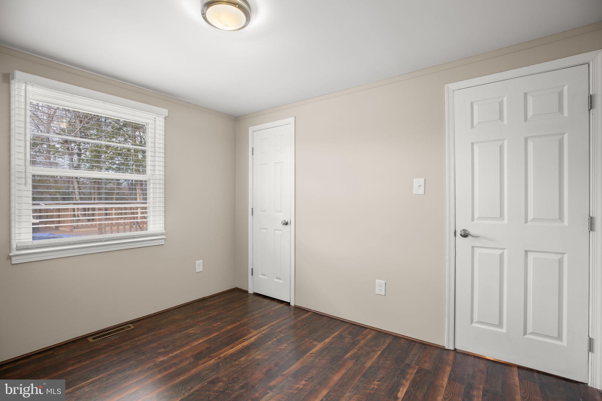 92 McCarty Road Fredericksburg, VA 22405 - Photo 25 of 39 a view of an empty room with wooden floor and a window