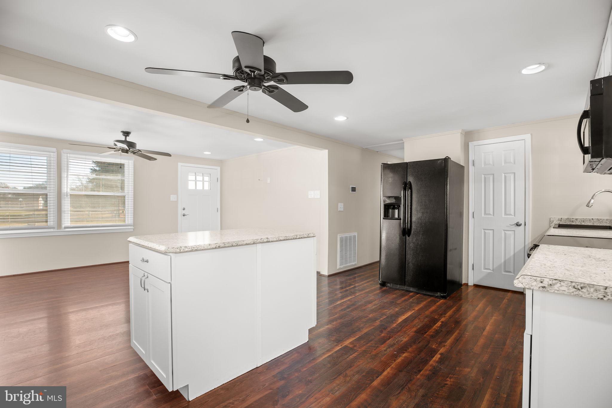 92 McCarty Road Fredericksburg, VA 22405 - Photo 7 of 31 a kitchen with stainless steel appliances a refrigerator a sink dishwasher and a stove with wooden floor