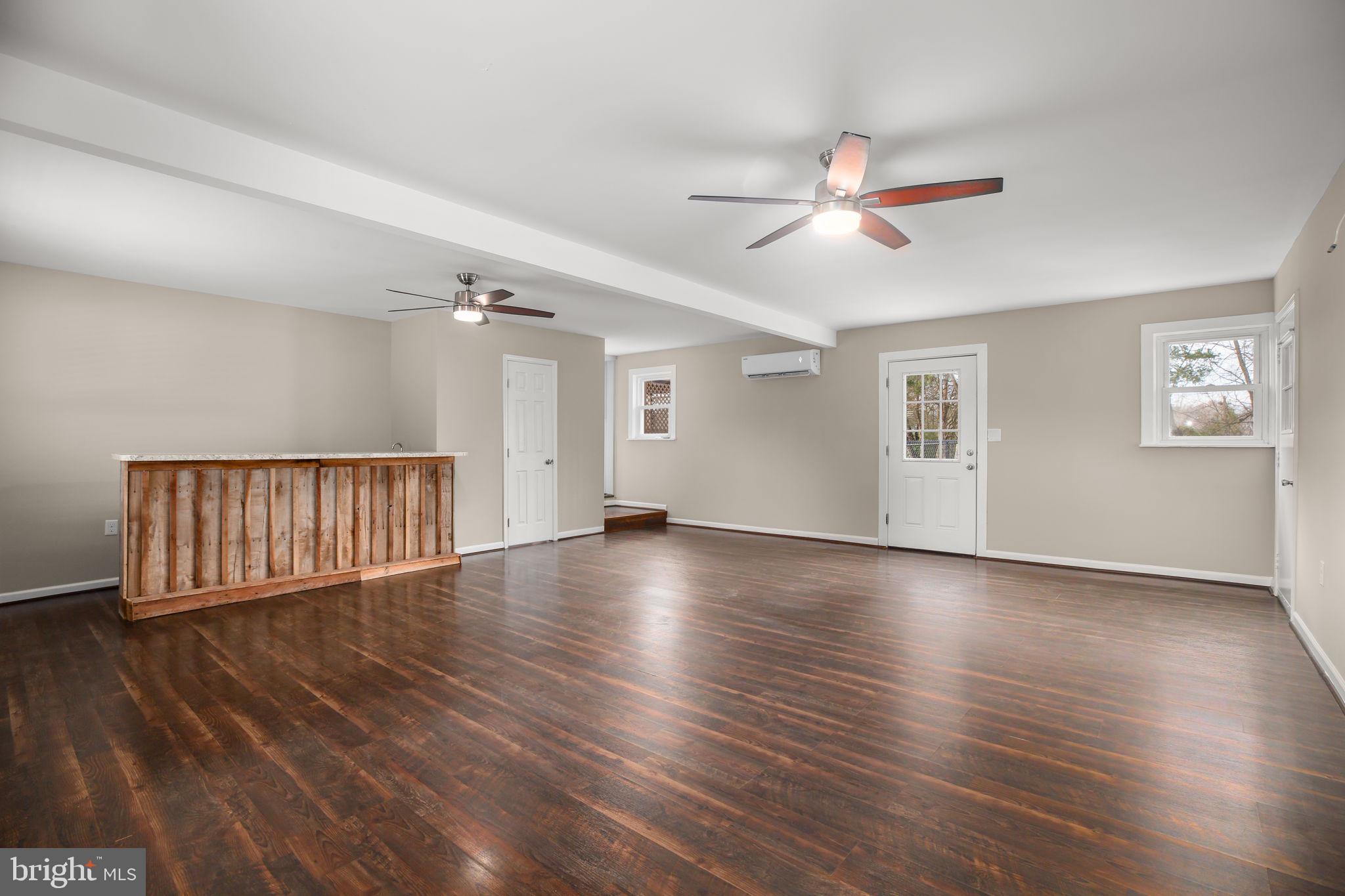 92 McCarty Road Fredericksburg, VA 22405 - Photo 9 of 31 a view of an empty room with wooden floor and a window