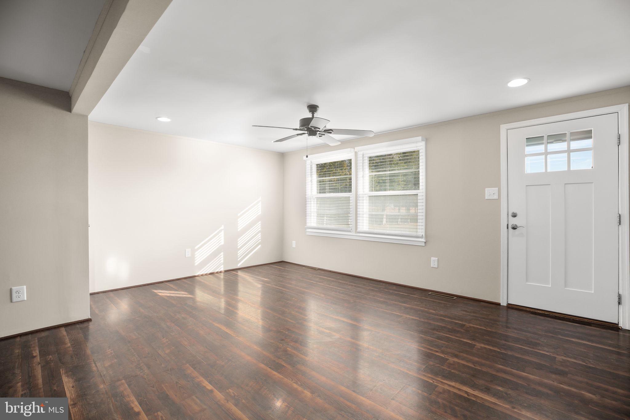 92 McCarty Road Fredericksburg, VA 22405 - Photo 10 of 39 a view of an empty room with wooden floor and a window