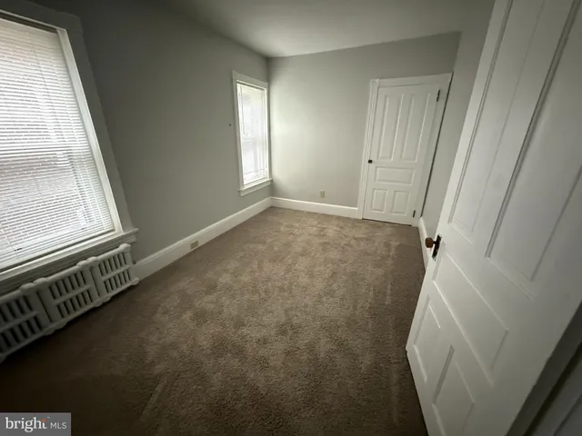 a view of an empty room and a window
