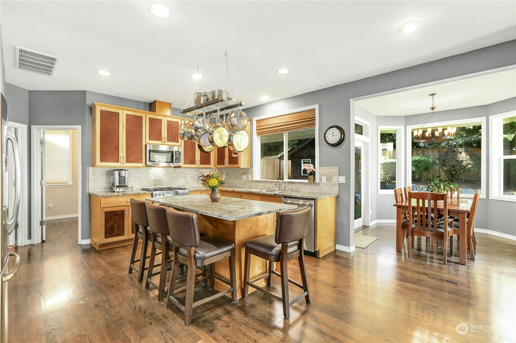 17309 106th Place Northeast Bothell, WA 98011 - Photo 11 of 39 a dining room with stainless steel appliances granite countertop a table chairs and a view of living room