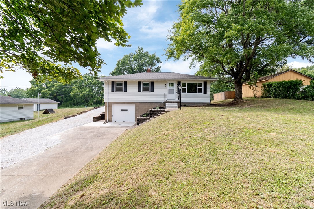 1716 Betz Road Akron, OH 44306 - Photo 2 of 28 Ranch-style home featuring driveway, an attached garage, a front yard, and a chimney