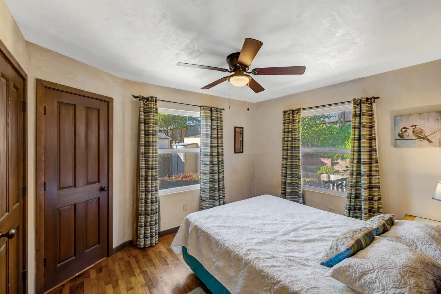 810 Altura Place Del Rey Oaks, CA 93940 - Photo 33 of 57 a bedroom with a large bed and wooden floor