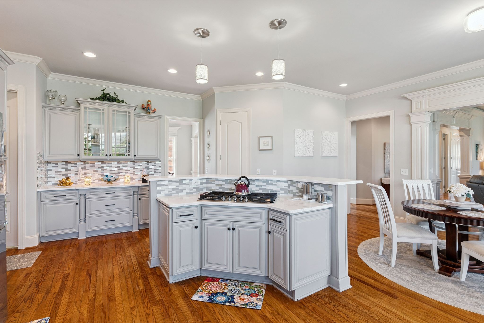 815 Stonebrook Drive Lebanon, TN 37087 - Photo 17 of 71 a kitchen with a stove a sink and white cabinets with wooden floor