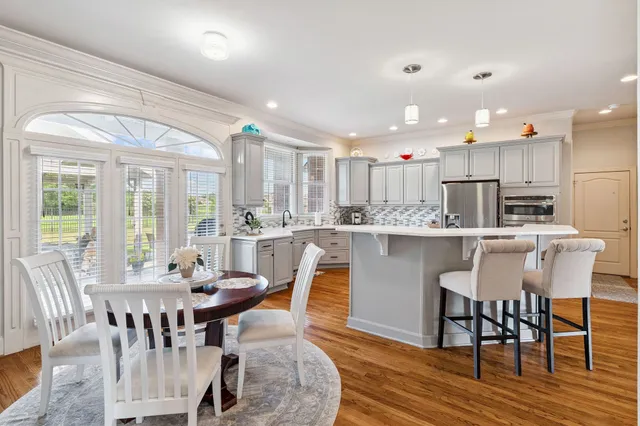 a view of cabinets a wooden floor and a window in the kitchen