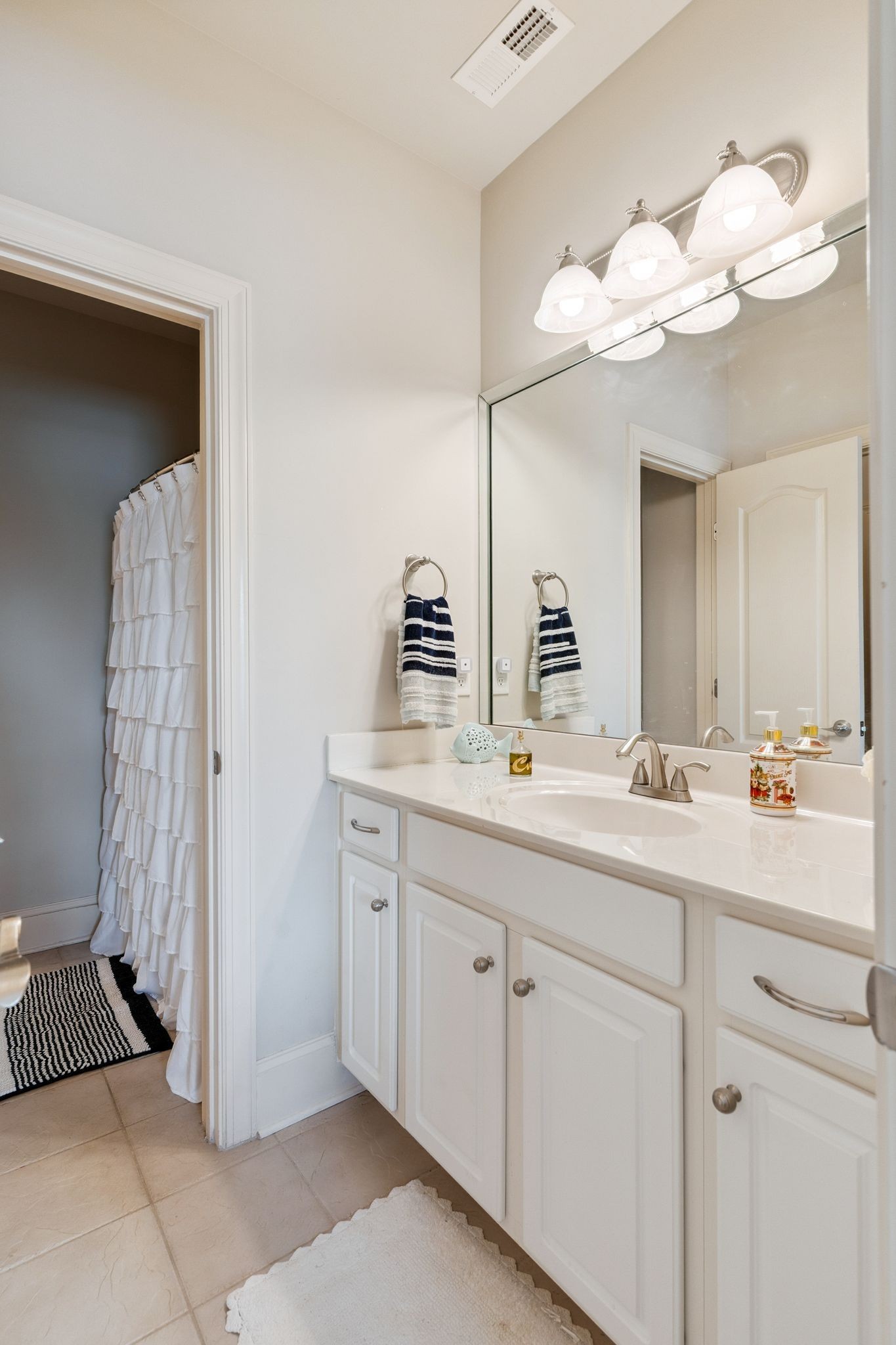 815 Stonebrook Drive Lebanon, TN 37087 - Photo 34 of 71 a bathroom with a sink a mirror and a shower