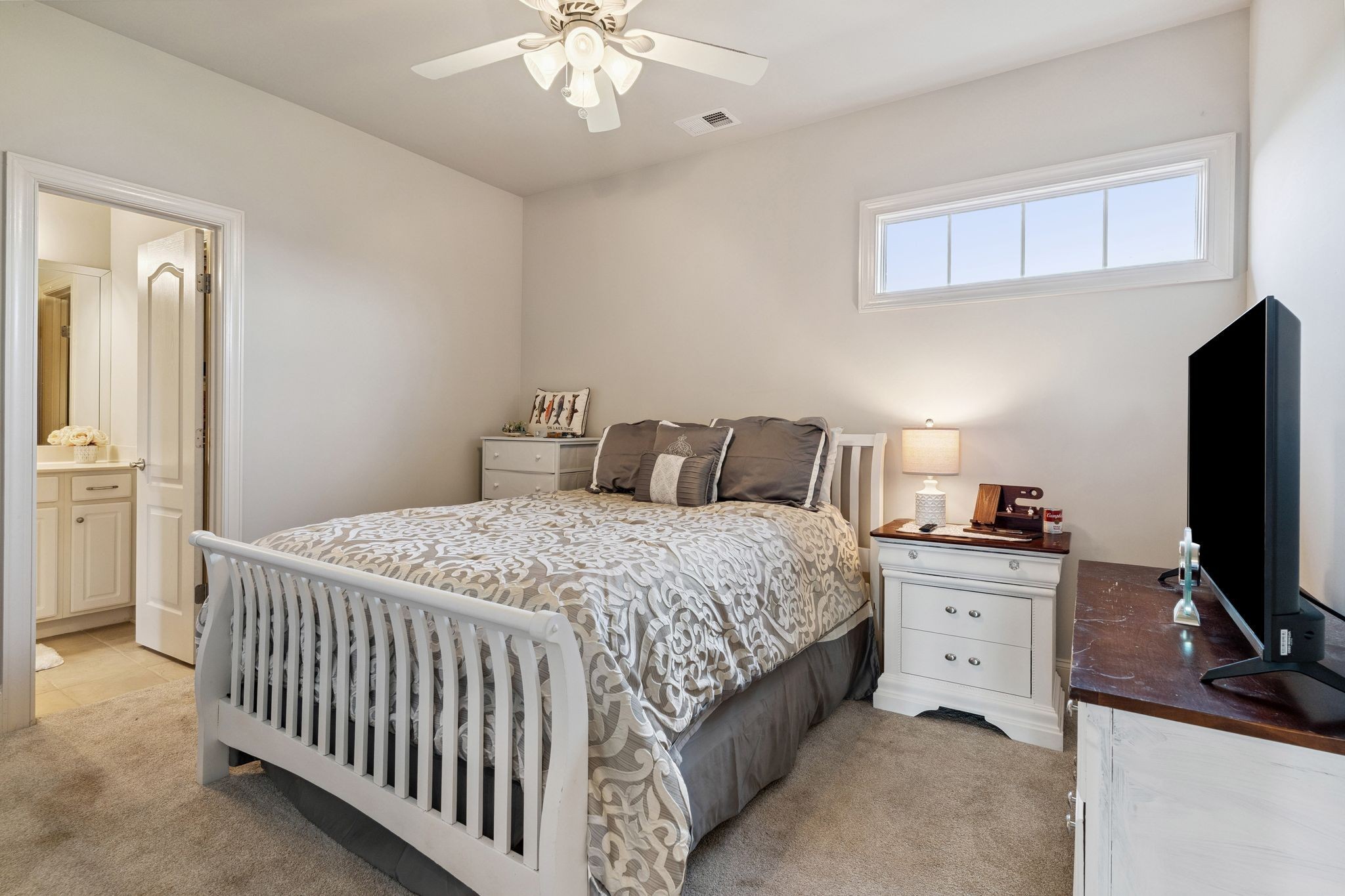 815 Stonebrook Drive Lebanon, TN 37087 - Photo 40 of 71 a bedroom with a bed and a flat tv screen on the dresser