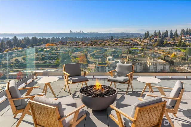 a outdoor dining space with furniture and city view