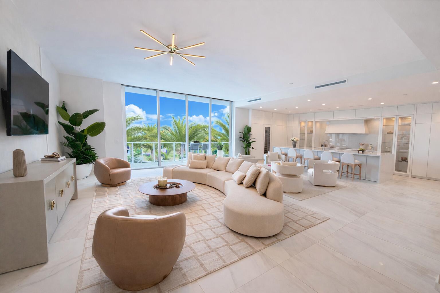 a living room with furniture a window and a flat screen tv