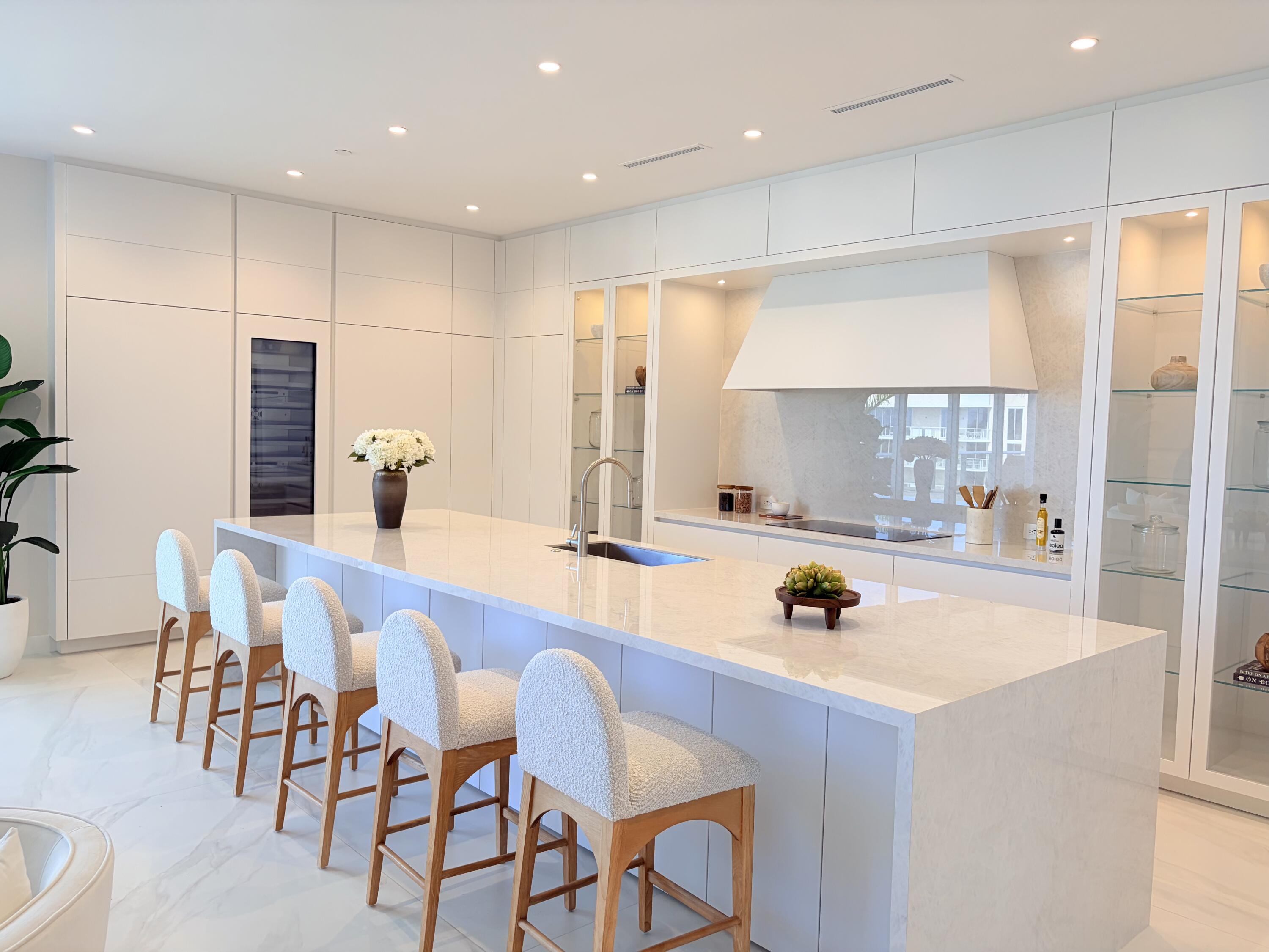 220 Southeast Mizner Boulevard, Unit PH907 Boca Raton, FL 33432 - Photo 6 of 29 a large kitchen with a table and chairs