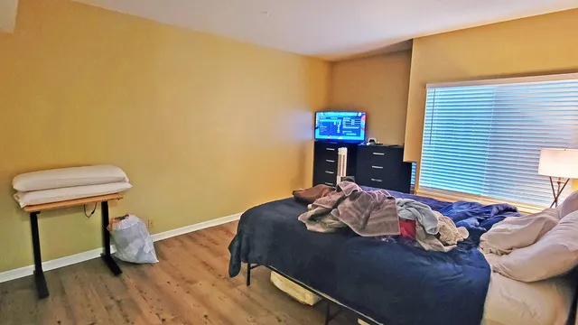 a bedroom with a bed and a table in it