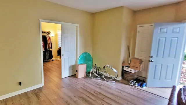 a view of a room with wooden floor and furniture