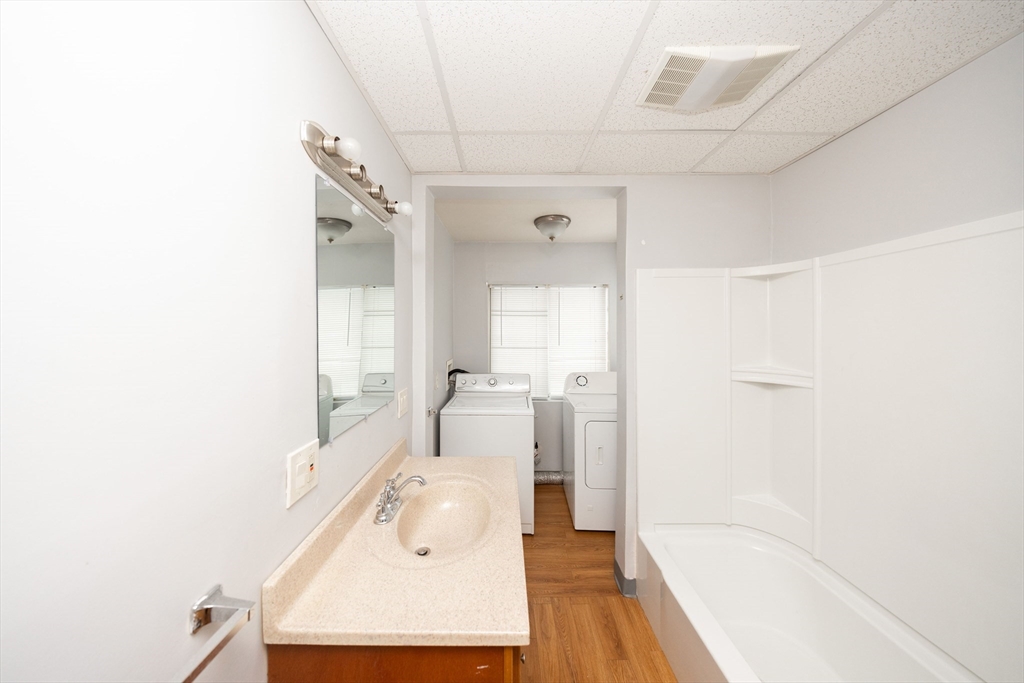 10 Alpine Street, Unit 1 Worcester, MA 01610 - Photo 14 of 14 a bathroom with a sink a mirror and a bathtub