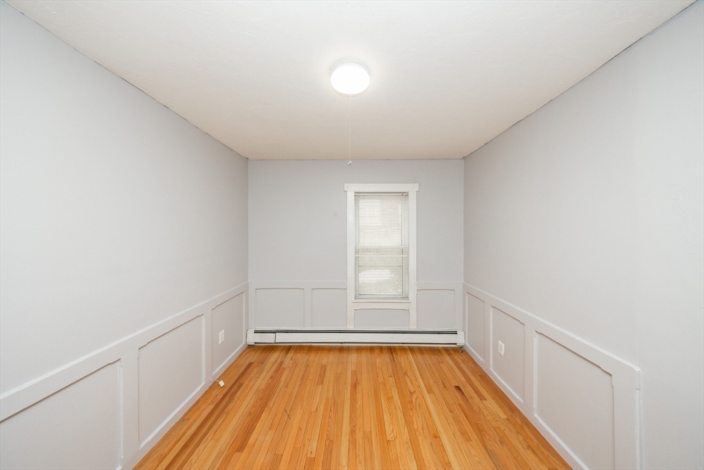 10 Alpine Street, Unit 1 Worcester, MA 01610 - Photo 9 of 14 a view of room with window and wooden floor