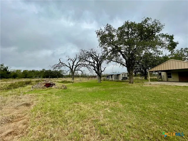 a view of a house with a yard porch and sitting area