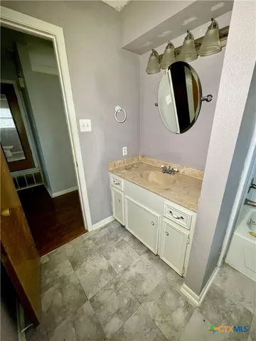 a bathroom with a double vanity sink and mirror