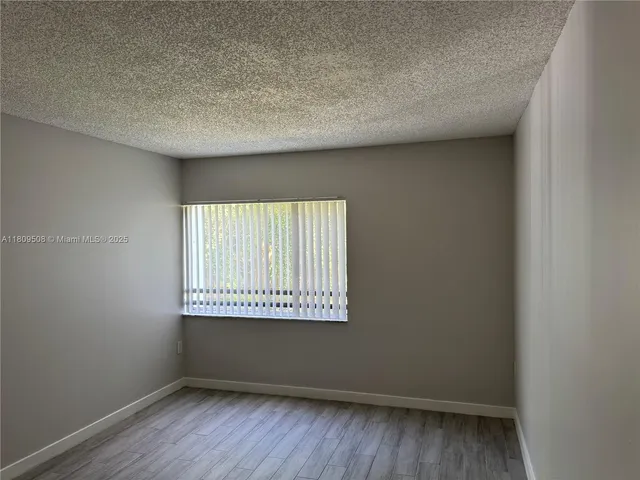 a view of an empty room and a window