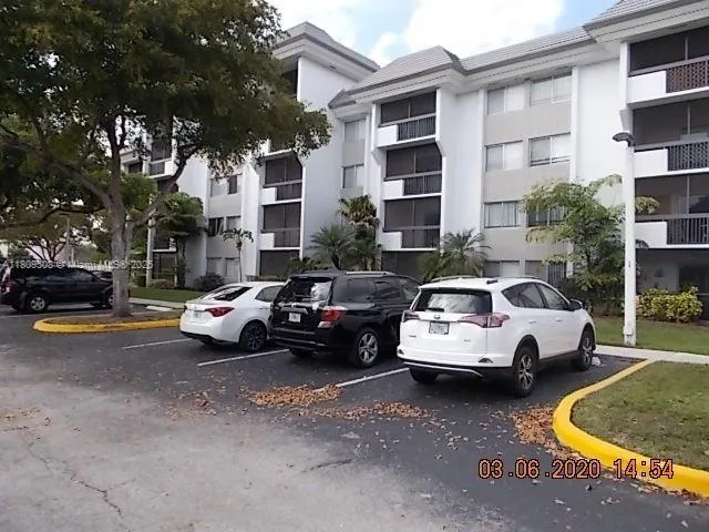 a car parked in front of a white house