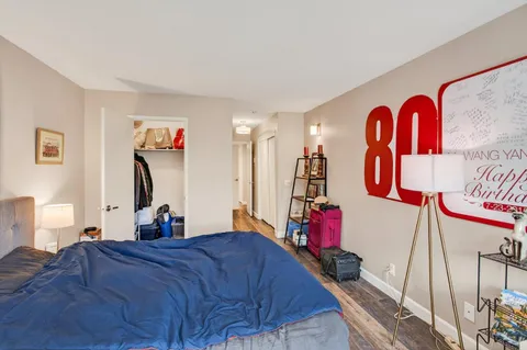 a bedroom with a bed and a large mirror