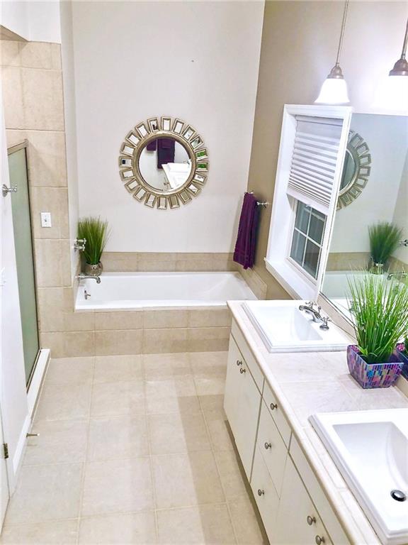 130 Lions Road Butler, PA 16001 - Photo 12 of 25 Master bathroom has gleaming ceramic tile floors, counters and shower. Relax in the deep soaking tub.