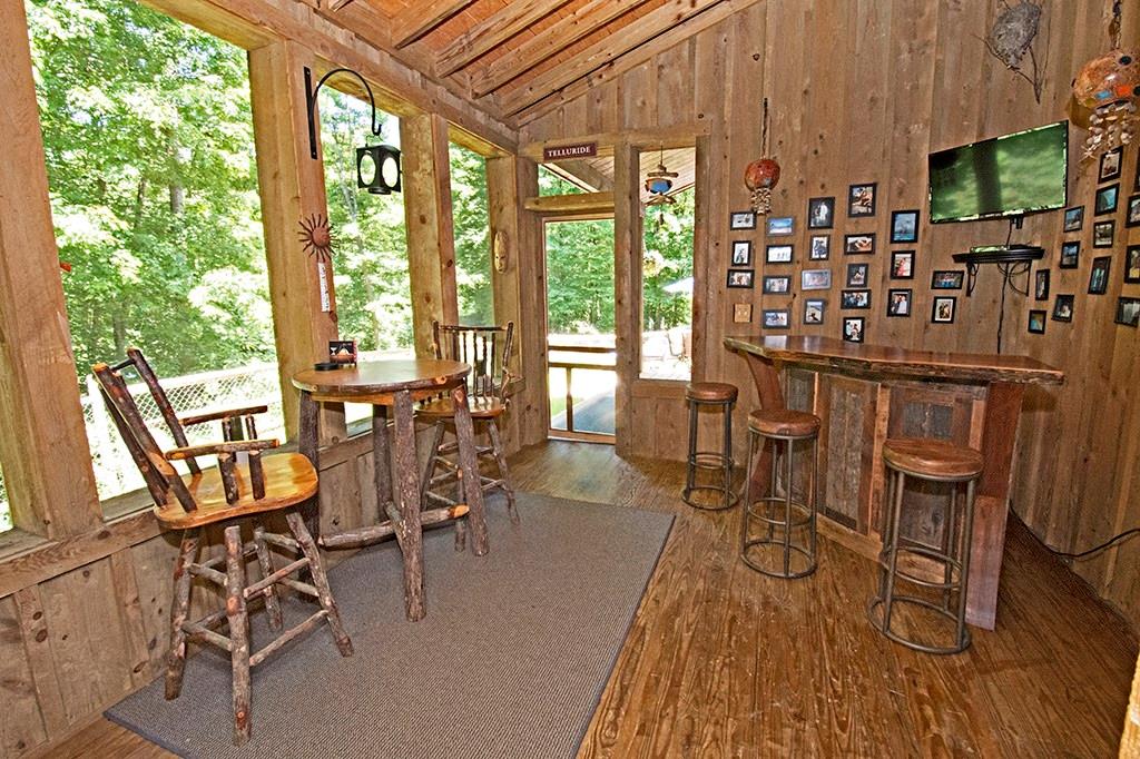 130 Lions Road Butler, PA 16001 - Photo 18 of 25 Wood lined screened porch provides another great option for enjoying views of the gorgeous property. This area connects to rear porch, side patio, and has access to kitchen.