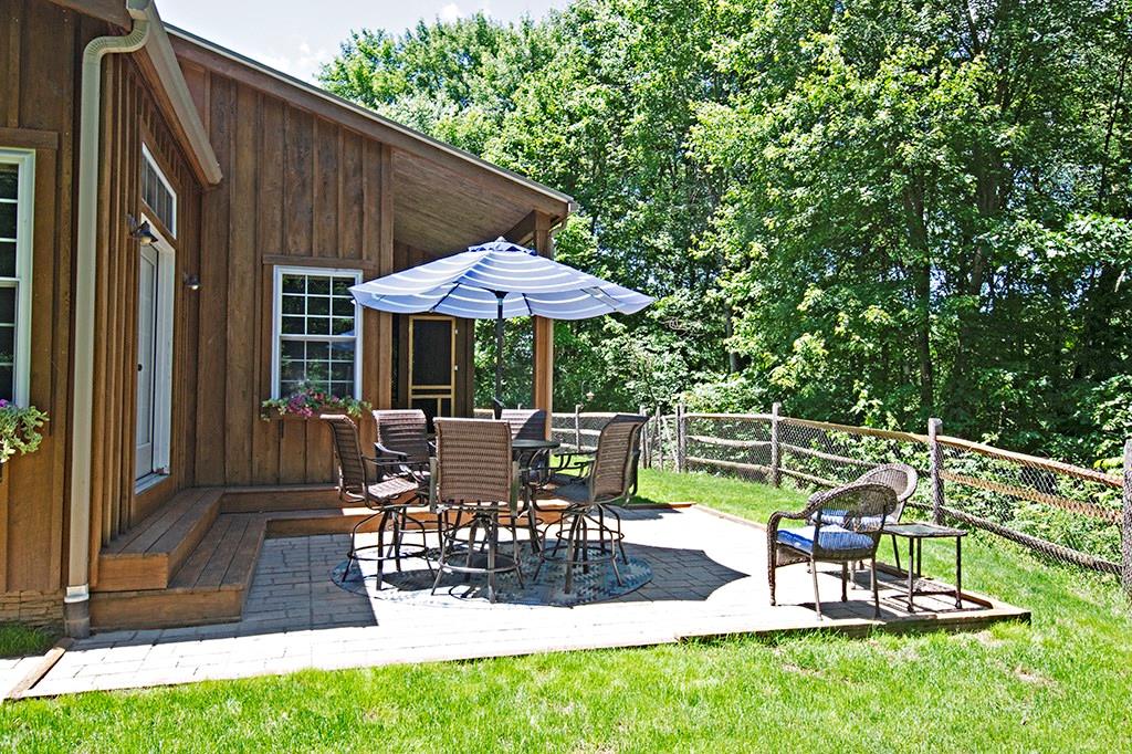 130 Lions Road Butler, PA 16001 - Photo 20 of 25 The side patio is fully fenced in and has a lovely view of the garden and lower fire pit area.