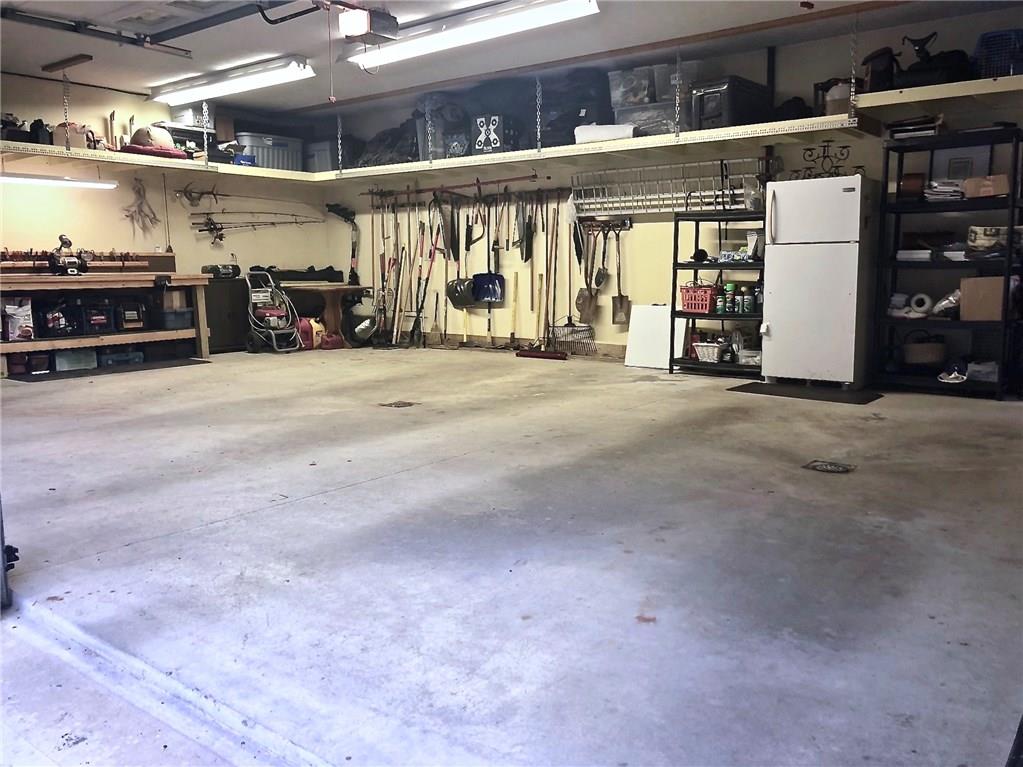 130 Lions Road Butler, PA 16001 - Photo 25 of 25 Large garage has a perimeter of overhead storage and a built-in work bench. In addition to 4 large shop lights, 2 windows add natural light. Avoid the elements by using man door to walk to house through covered breezeway.