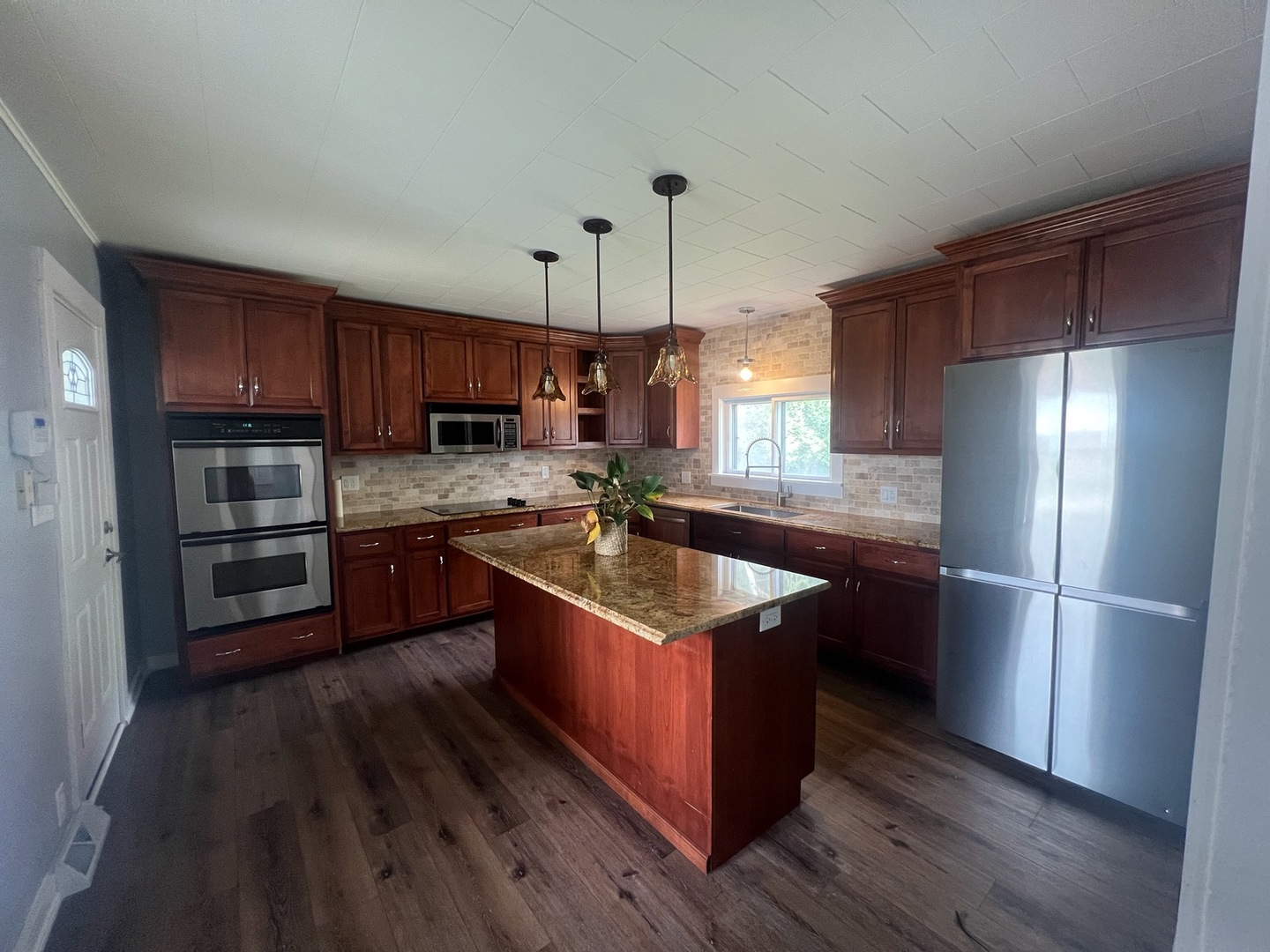 31383 East Five Points Road Kingston, IL 60145 - Photo 3 of 25 a kitchen with stainless steel appliances granite countertop a refrigerator a sink dishwasher a stove and a oven with wooden floor