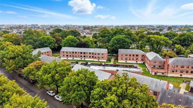 an aerial view of a house with swimming pool big yard and large trees