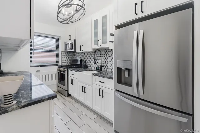 a kitchen with stainless steel appliances a refrigerator sink and cabinets