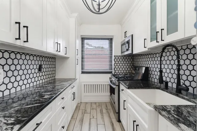 a kitchen with a sink and a stove top oven