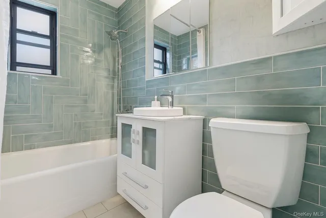 a bathroom with a sink a toilet and bathtub