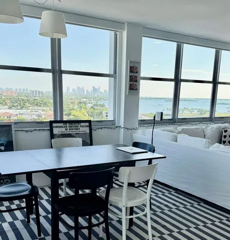 a dining room with furniture window a table and chairs