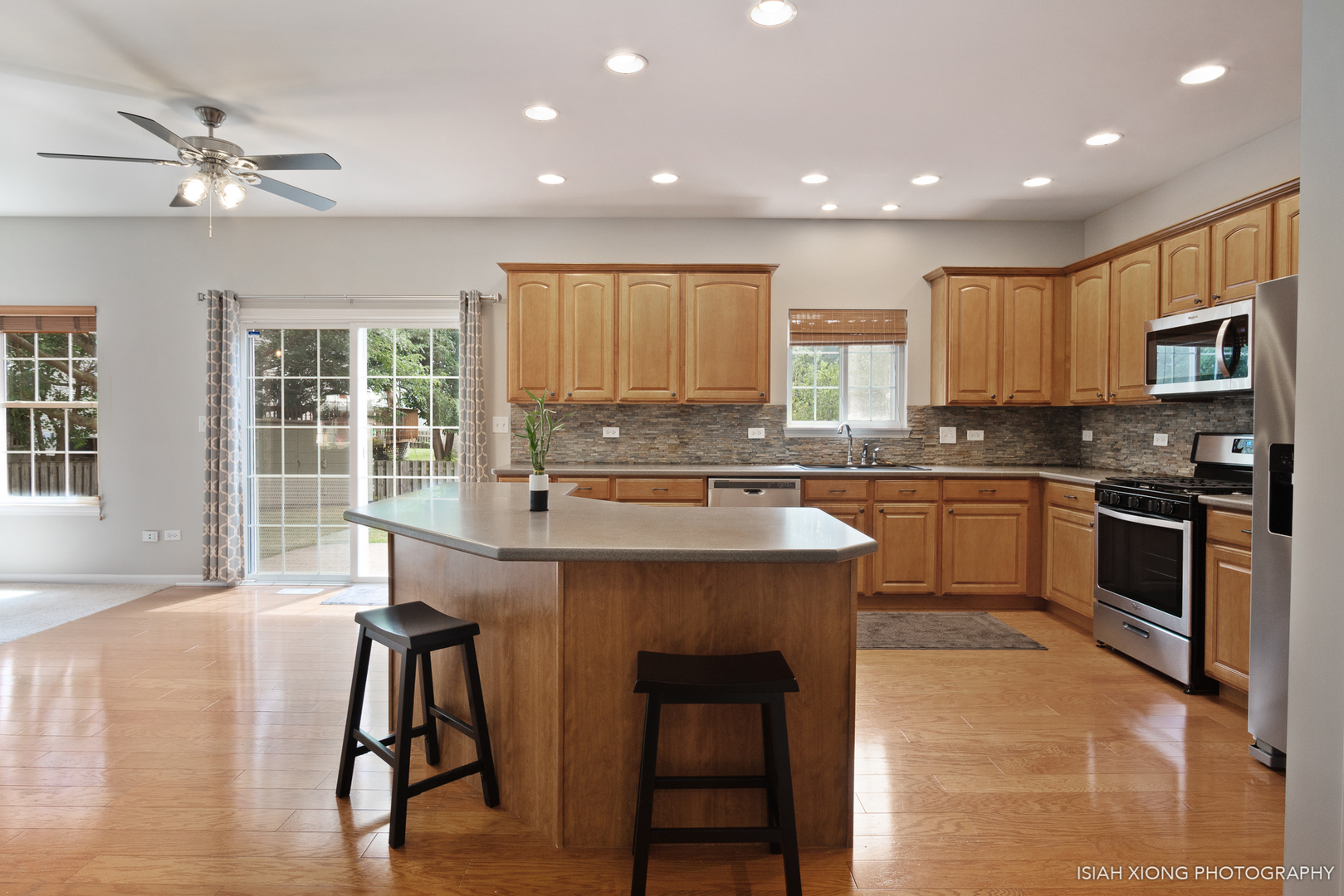 3255 Marbill Farm Road Montgomery, IL 60538 - Photo 5 of 22 a kitchen with a stove a sink a microwave and cabinets