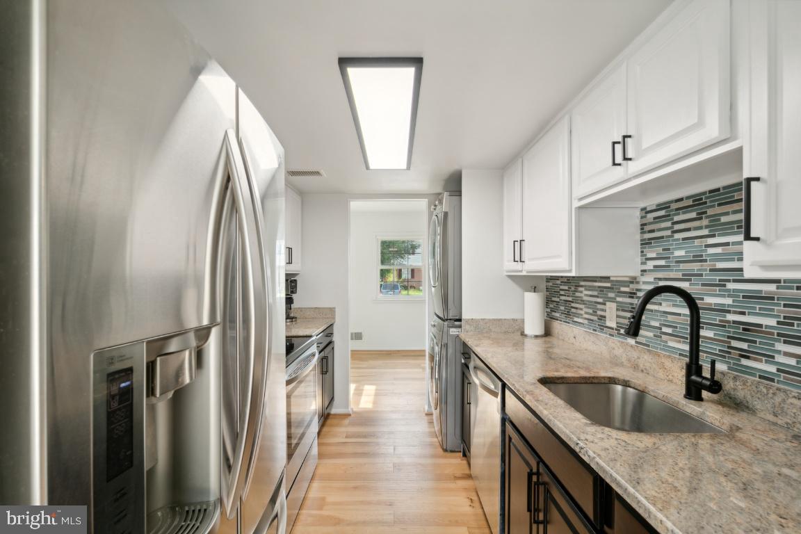 2400 Kilpatrick Place Dumfries, VA 22026 - Photo 8 of 20 a kitchen with stainless steel appliances granite countertop a sink refrigerator and cabinets
