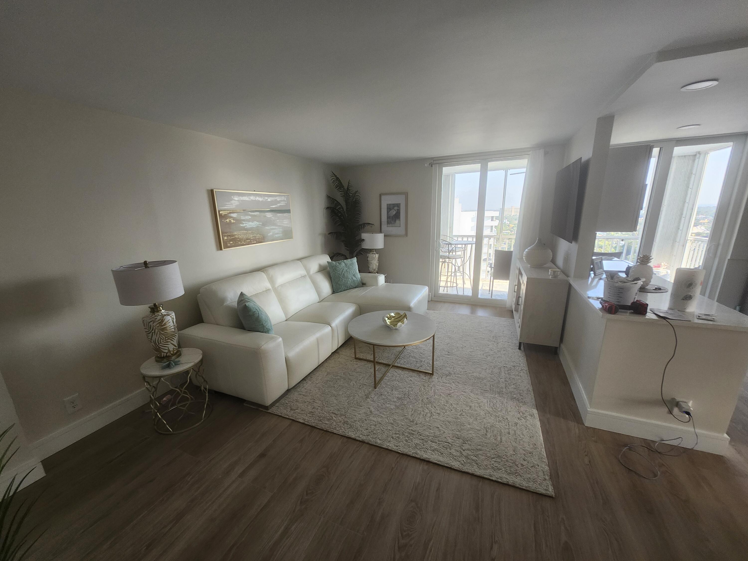 1505 North Riverside Drive, Unit 1108 Pompano Beach, FL 33062 - Photo 5 of 16 a living room with furniture and a wooden floor