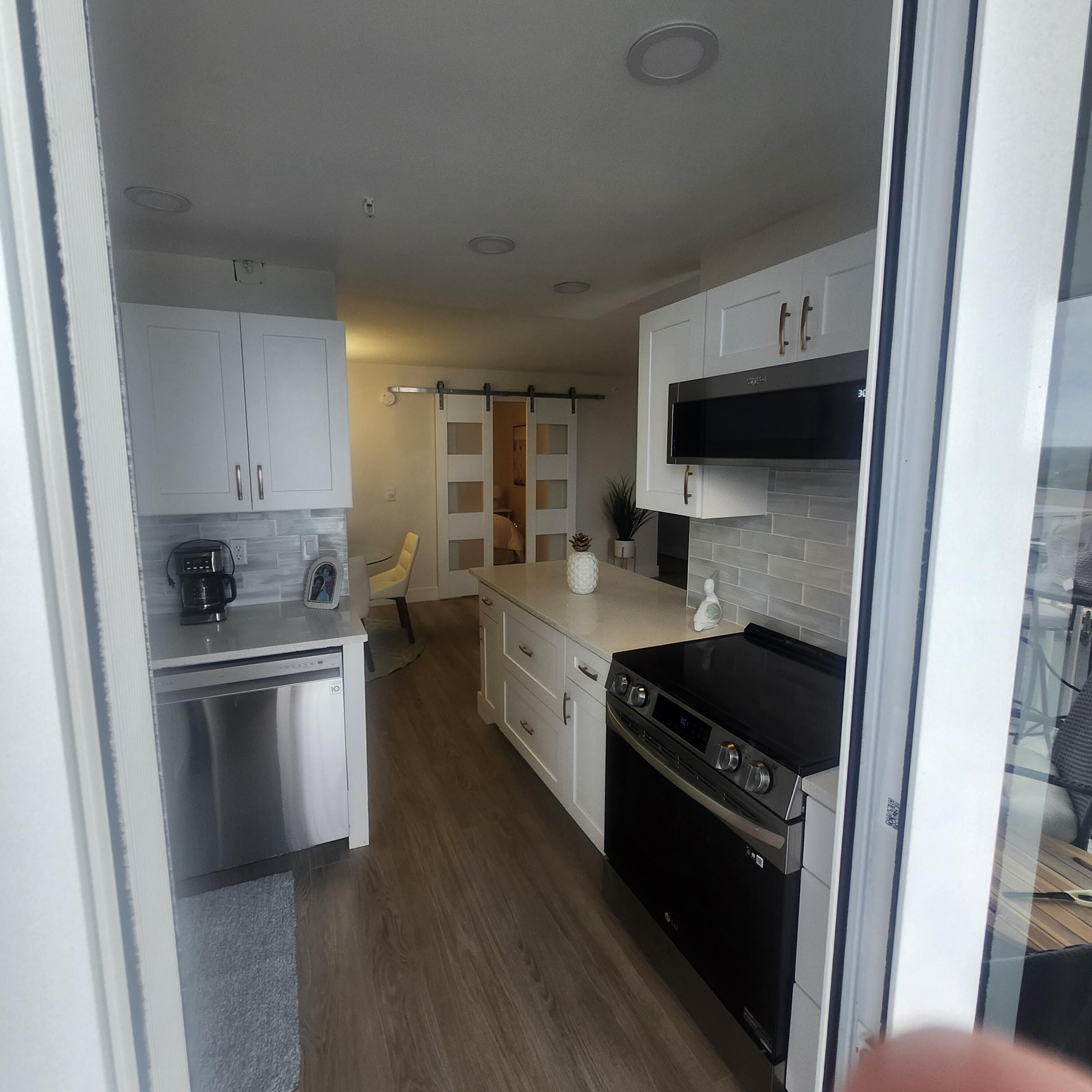 1505 North Riverside Drive, Unit 1108 Pompano Beach, FL 33062 - Photo 9 of 16 a kitchen with stainless steel appliances granite countertop a stove a sink and a refrigerator